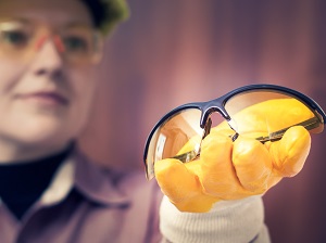 Professional Handing Safety Glasses to Co-Worker to Wear
