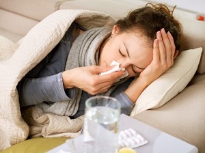 Sick Woman Laying on Couch