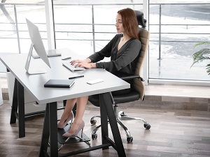 Woman Sitting at Work Desk with Good Posture