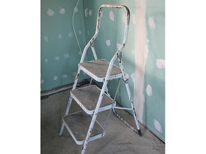 Step stool with three steps used for indoor painting project.