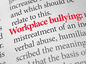 Page from dictionary showing definition of workplace bullying.