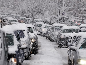 Traffic during a blizzard with lots of snow and cars.