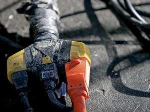 Extension cord with multiple plugs covered in electrical tape.