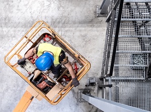 Overhead view of a construction worker on an aerial lift.