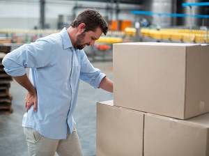 Warehouse worker that has back pain from lifting heavy boxes.