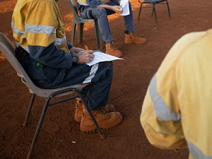 Construction worker safety meeting outside.