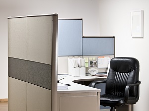 Office cubicle that is very neat and tidy.