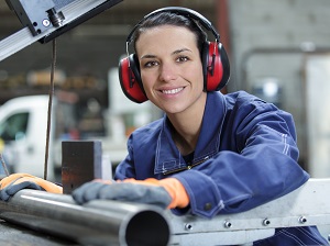 Industrial worker wearing earmuffs for hearing protection.