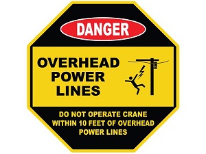 An octagonal warning sign that is yellow and black that says, "Danger, Overhead Power Lines, Do Not Operate Crane Within 10 Feet of Overhead Power Lines."