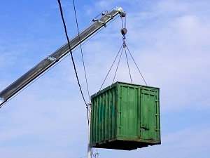 A crane lifting a heavy load near overhead power lines.
