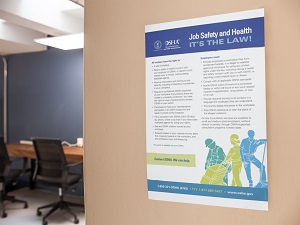 An office that has the OSHA poster hanging on the wall.