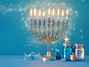 A Hanukkah menorah set against a blue background.