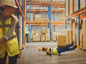 A warehouse worker that has been struck by a falling box.