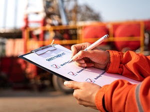 A worker with a checklist on a clipboard.