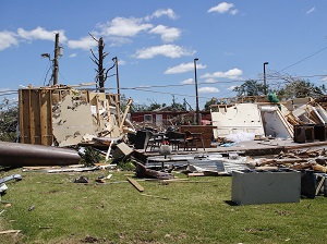 The aftermath of a tornado with buildings that are destroyed.