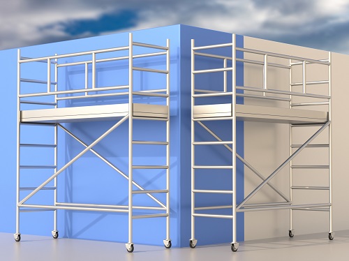 Two mobile scaffolds set against a blue wall.