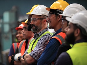 Workers wearing PPE standing in a line.