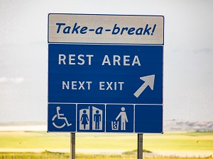 A highway sign that says Rest Area Next Exit.