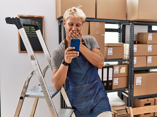 A worker on his cell phone at work.