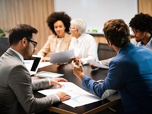 A committee meeting with multiple people in attendance.