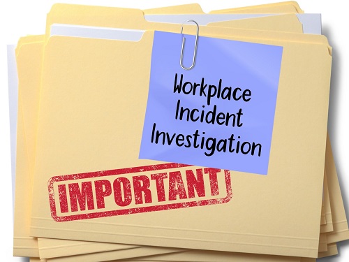 Stacked manila folders, the top one has a post-it note that says Workplace Incident Investigation