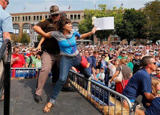 DxE's Araceli Rodriguez dragged off of stage after disrupting Chris Christie's talk in Iowa.