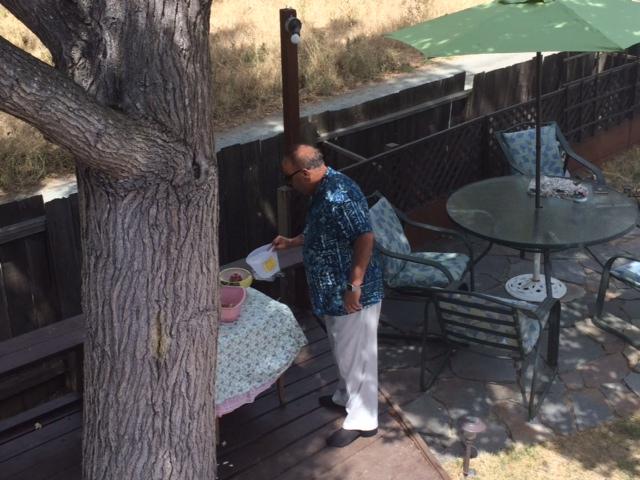 Dad giving cool water to the birds.
