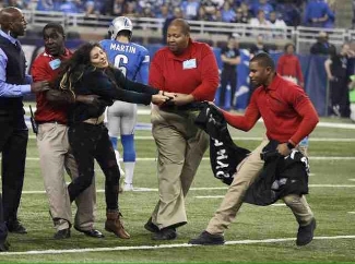 Araceli Rodriguez is dragged off the field by security.