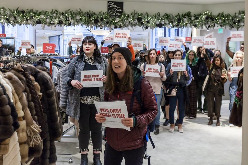 Almira Tanner and dozens of others protest inside Saks Fifth Avenue’s “Fur Salon.”