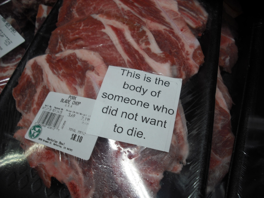 A package containing animal flesh has a sticker on it that reads