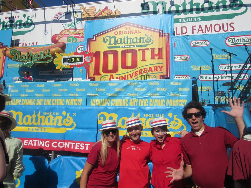 4 activists -- Amanda, Jared, Rachel, and Chris from left to right -- fit in with the crowd before disrupting the contest