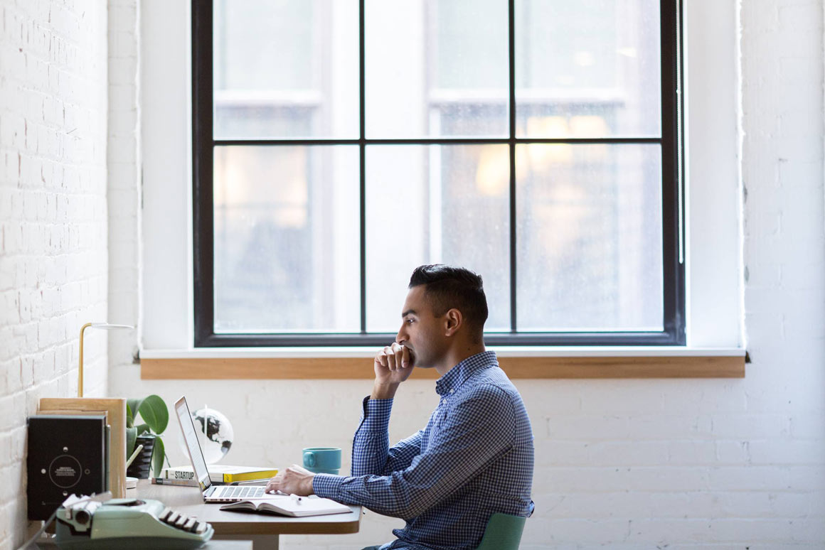 A man working remotely in his home office.