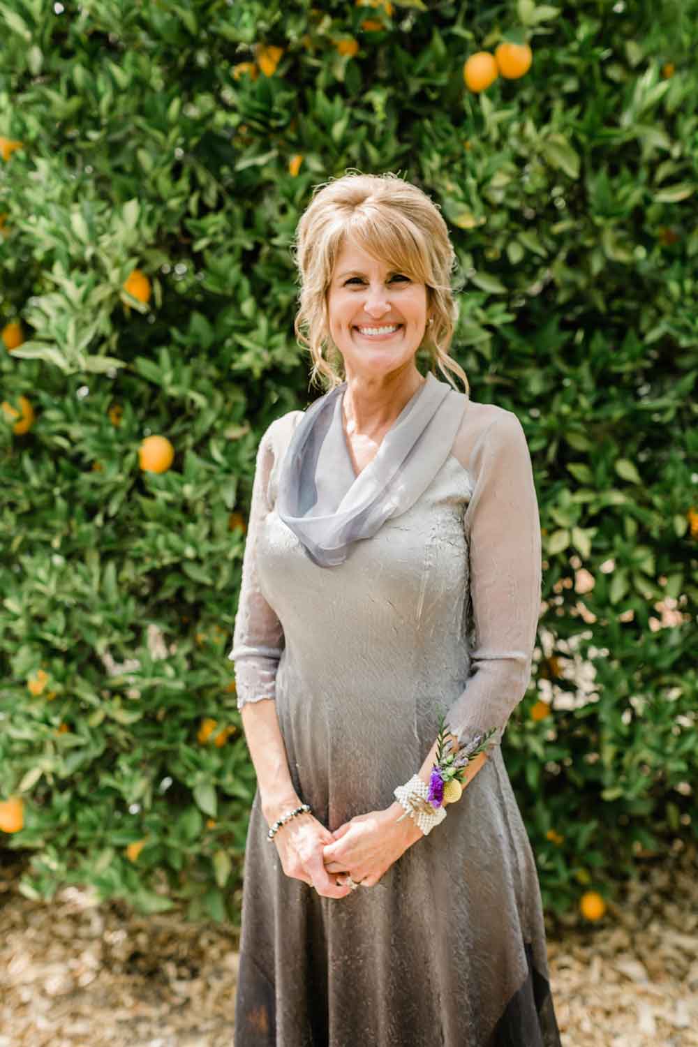 Deborah O'Hara standing in front of Redlands orange groves
