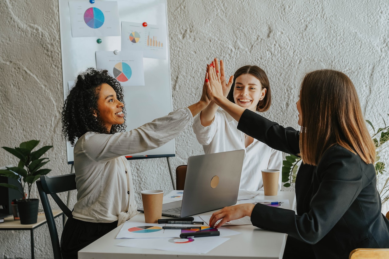 Employees being recognised by a manager with high five