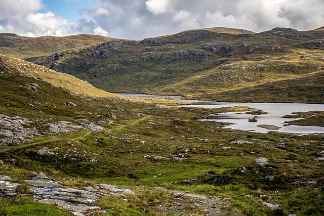 Scottish hills with lake in midge season around the country