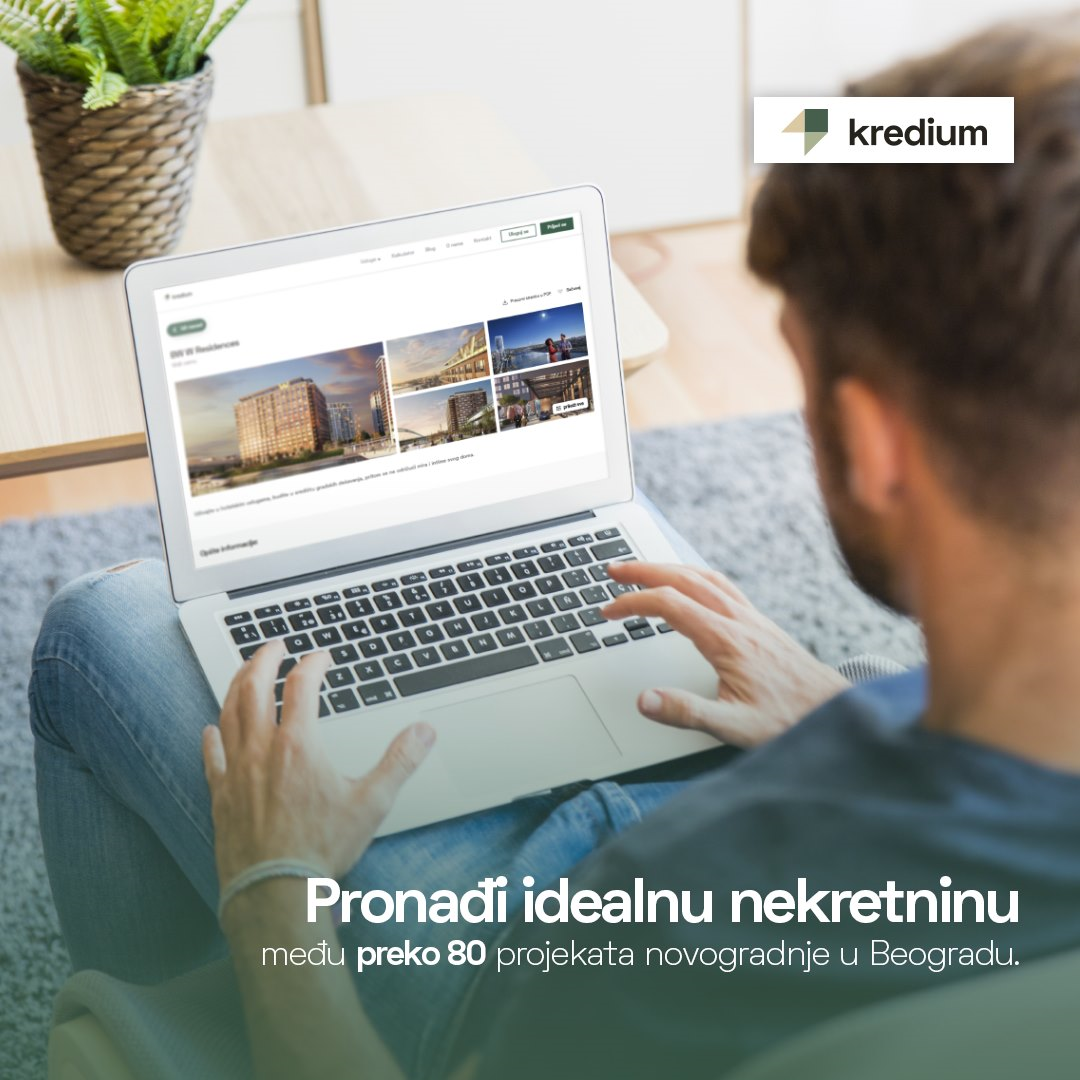 Momak u krilu drži laptop i pretražuje ponudu nekretnina na internetu.