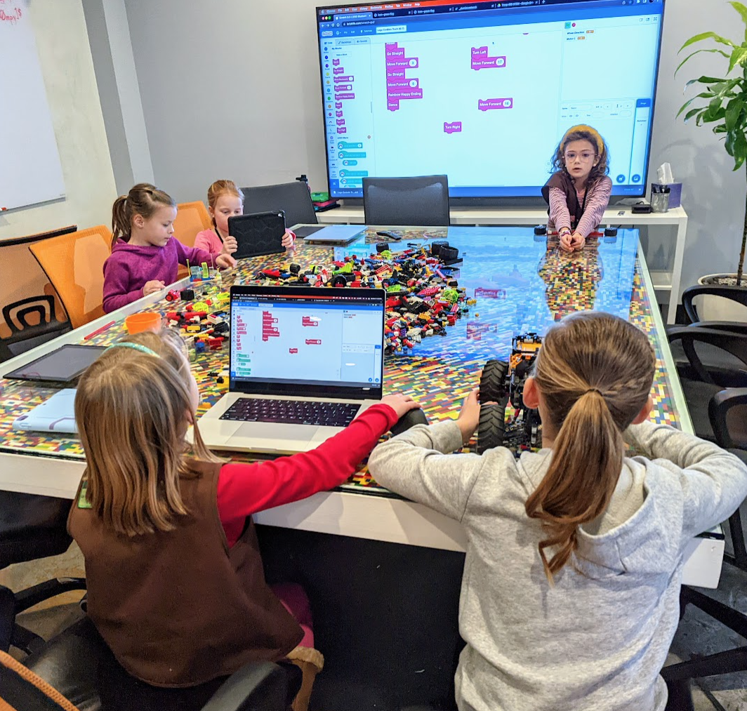 Girl Scout troop in the Integrity offices learning about web development, coding and 3D printing
