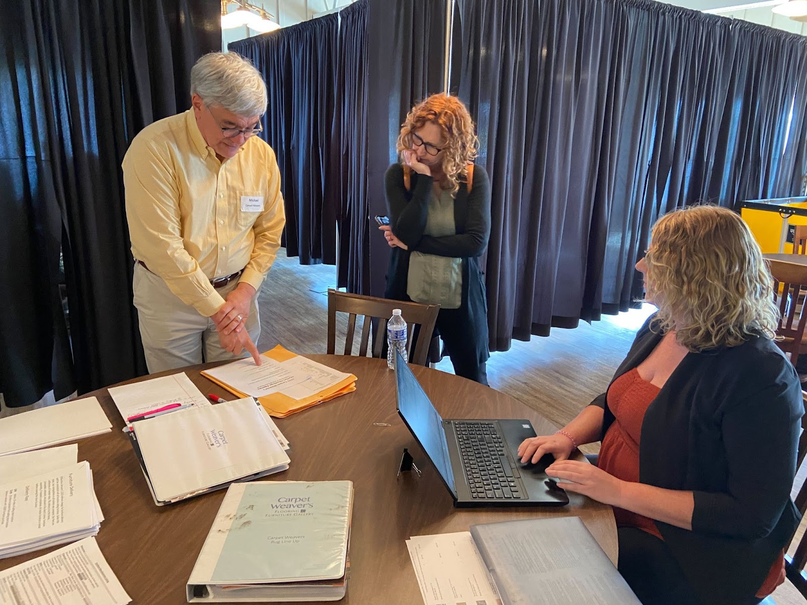 Integrity's Kim House working with Carpet Weaver's employees during a round table discussion.