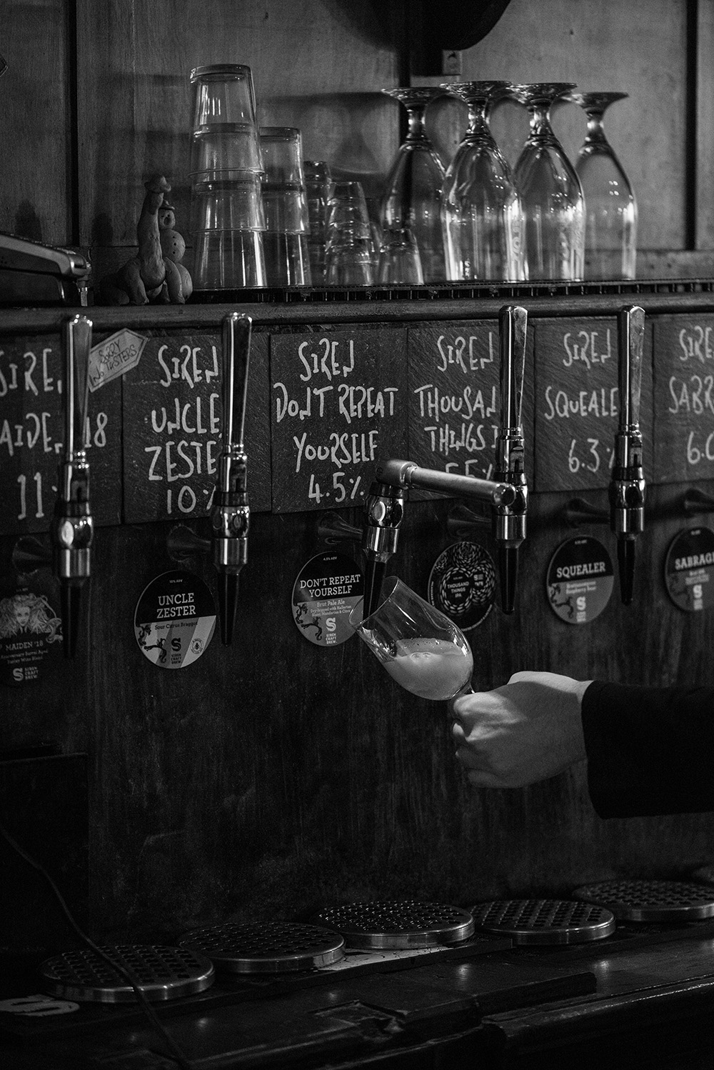 Black and white image of a third of beer being poured at the Brighton Beer Dispensary. The beer is Siren's Don't Repeat Yourself at 4.5% ABV