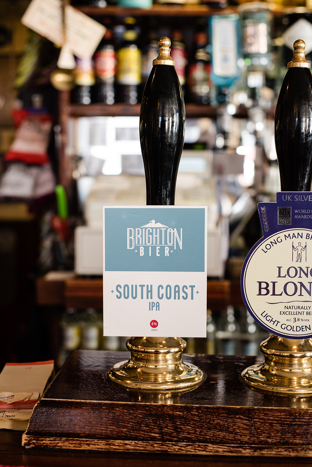 Hand pull beer tap at Brighton Bier. The light blue label says "South Coast IPA"