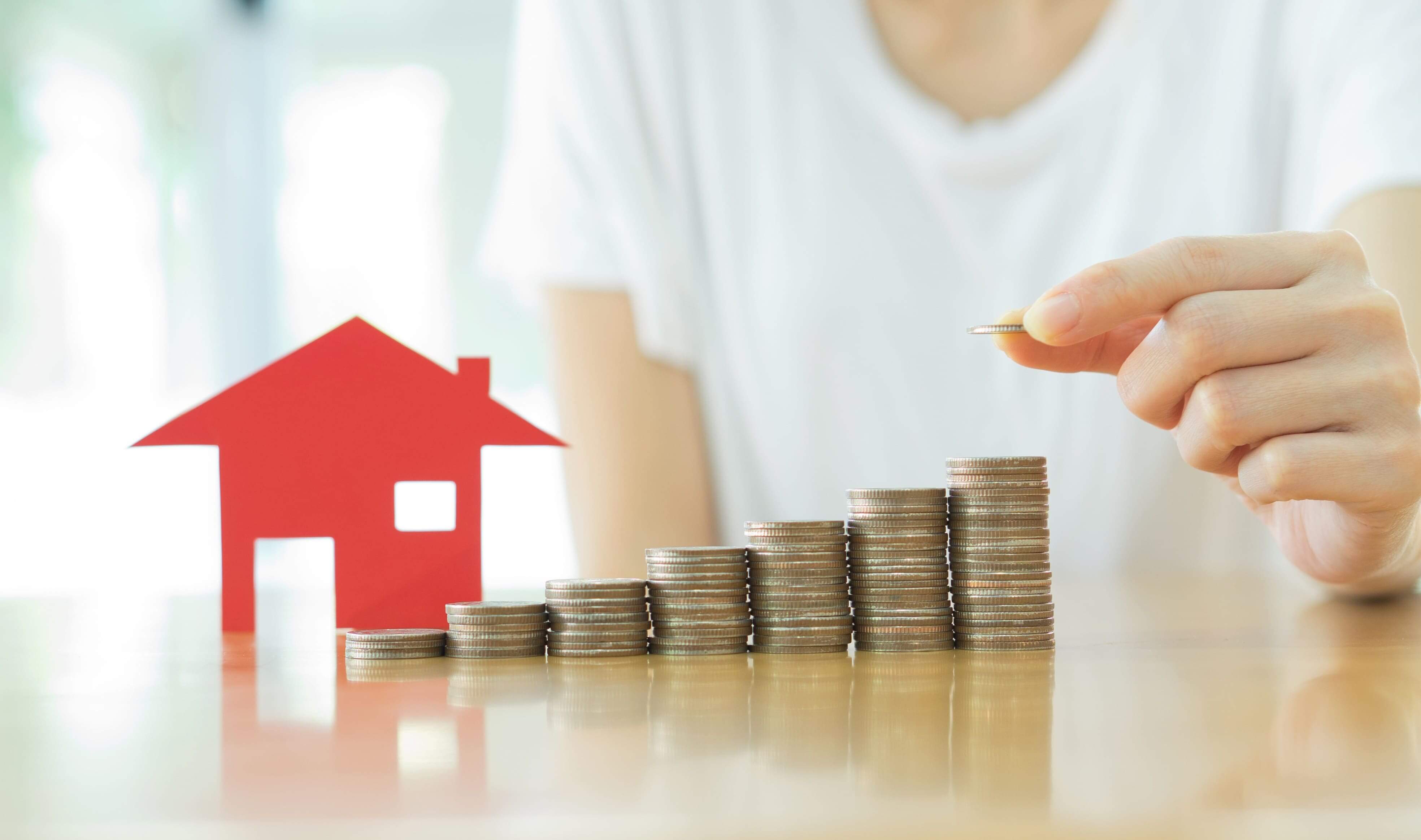 Rental property next to coins stacking up
