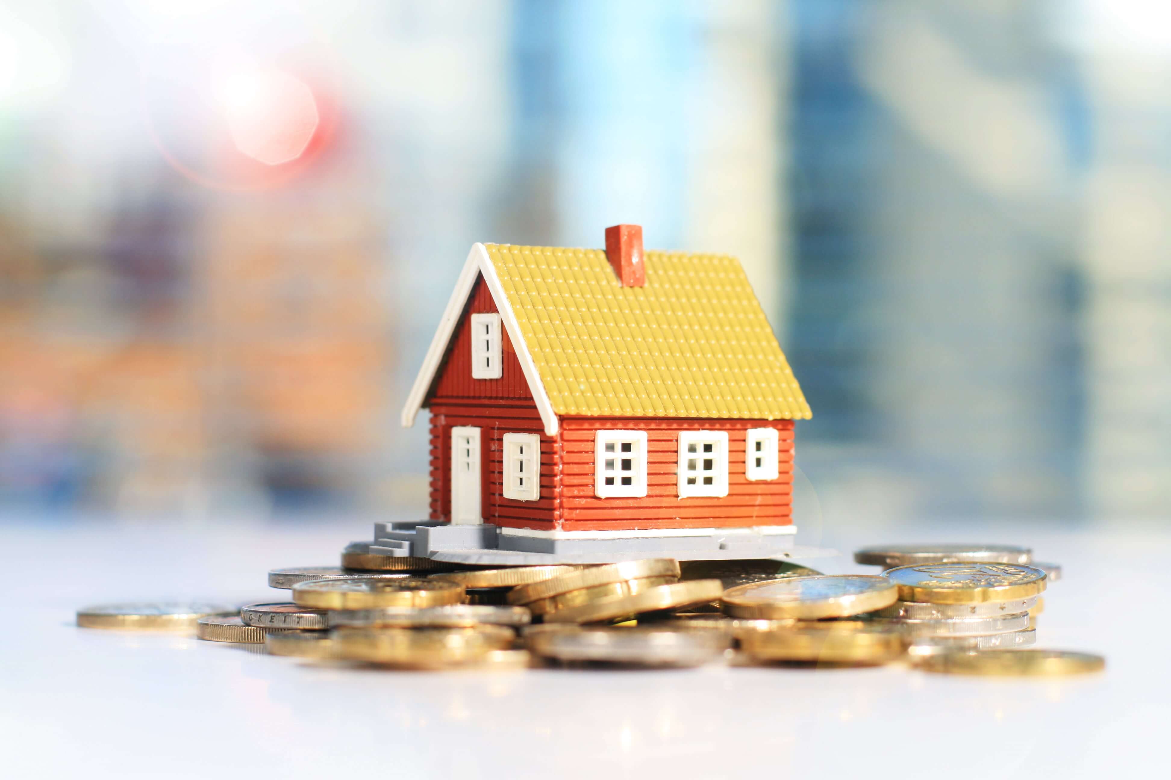 Cash on cash return - mini house sitting on top of coins