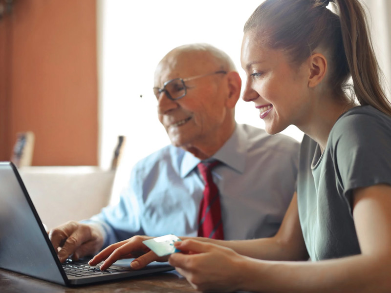 Man and Woman with computer and credit card.