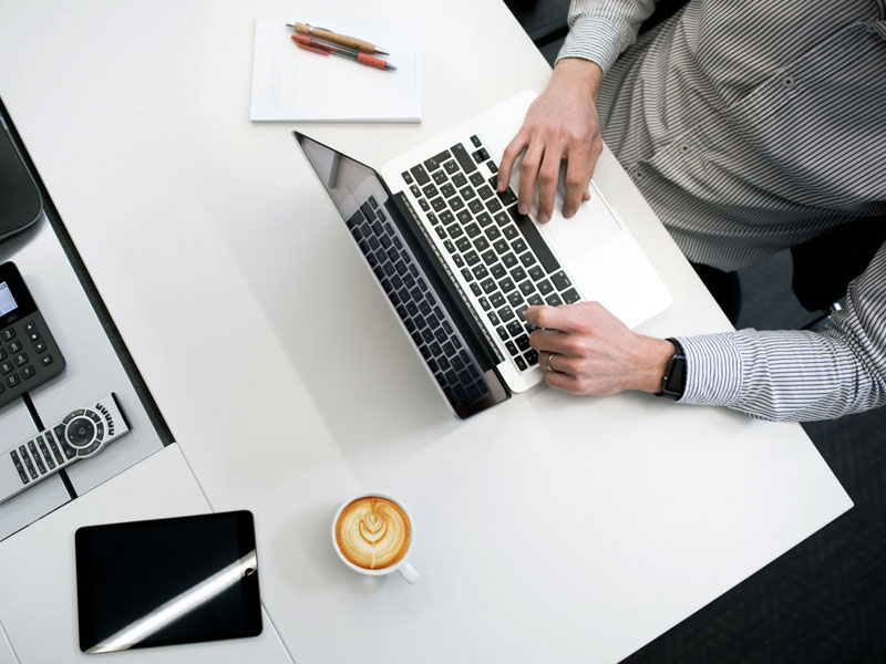 Business man sitting on a desk.