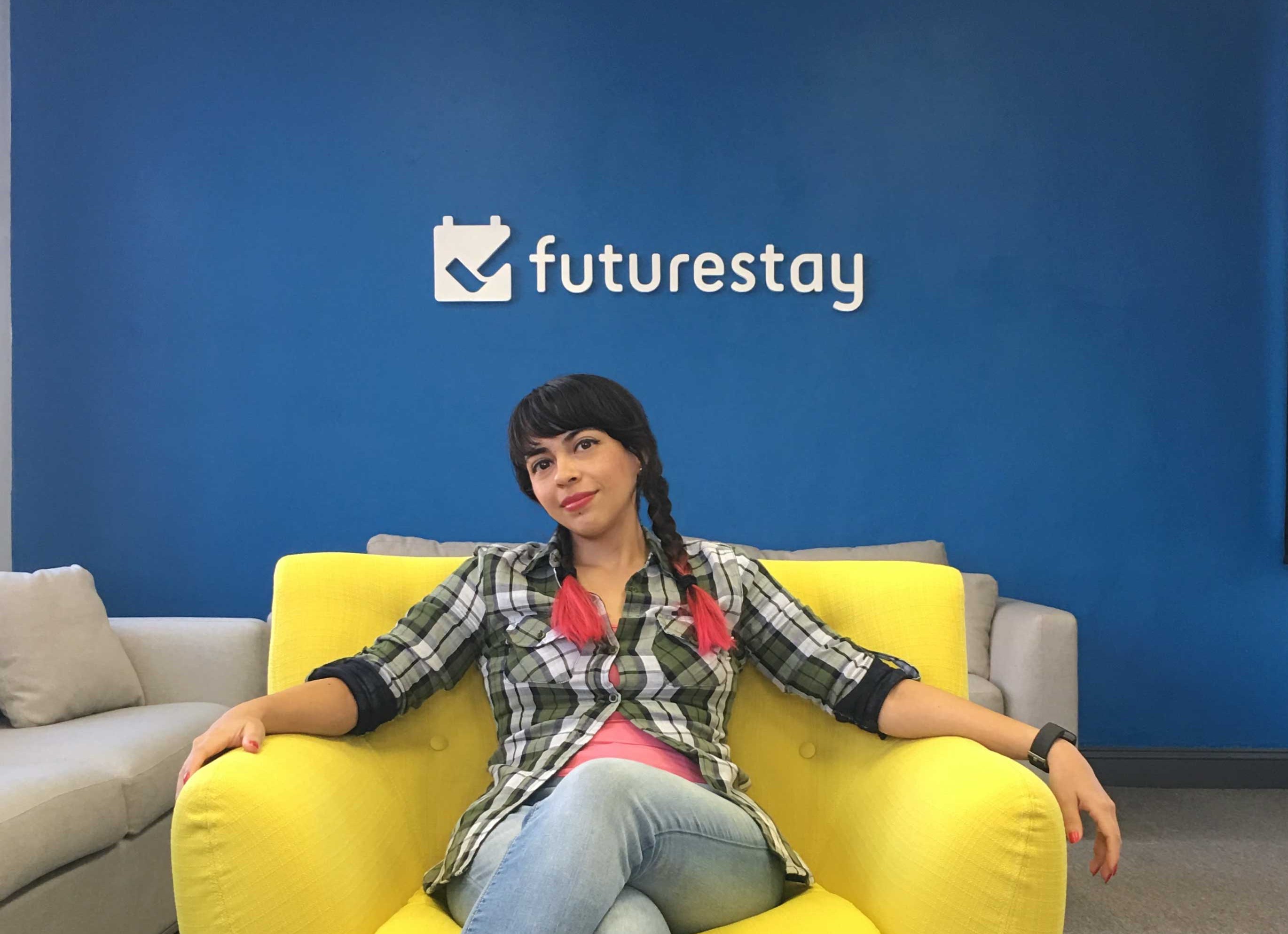 Abbi in front of the Futurestay logo
