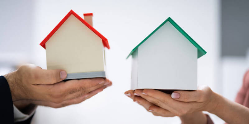 Part Exchange: What it is, how to do it - main image. Image of people swapping houses.