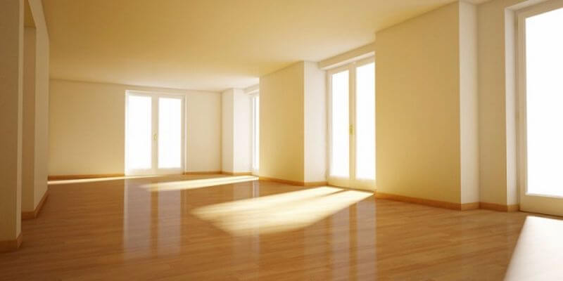 Owning/Selling an empty house. Image of a bare property with sun coming through the windows.