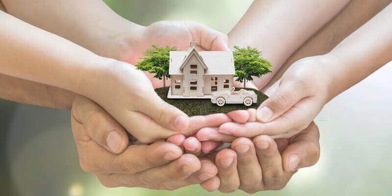 Image of a family all holding a model home: Do you need to pay stamp duty on an inherited home?