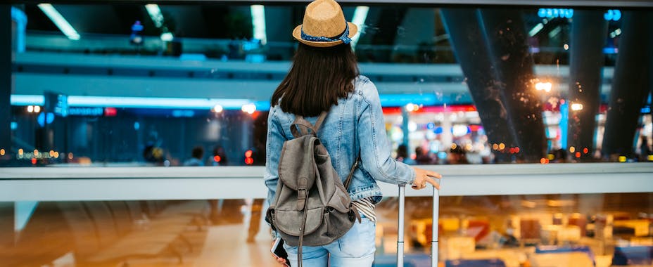 Traveler looking out airport window