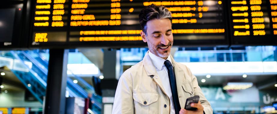 Traveler at airport on mobile phone